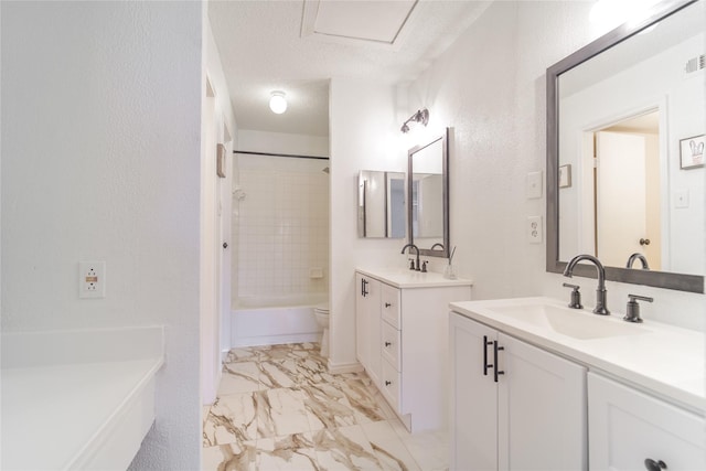 full bathroom featuring a sink, a textured ceiling, shower / bathing tub combination, marble finish floor, and two vanities