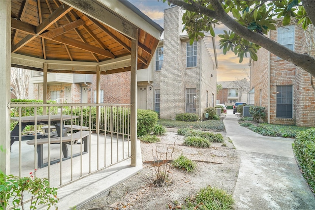 doorway to property featuring a chimney and brick siding