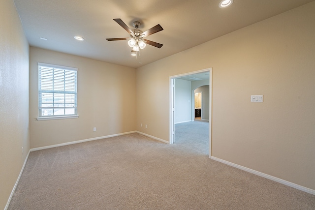 18922 Deer Trace Dr, Crosby, TX 77532 - spare room with light colored carpet, ceiling fan, arched walkways, and baseboards