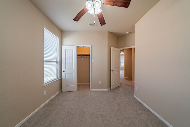 18922 Deer Trace Dr, Crosby, TX 77532 - unfurnished bedroom featuring light colored carpet, a ceiling fan, multiple windows, and visible vents