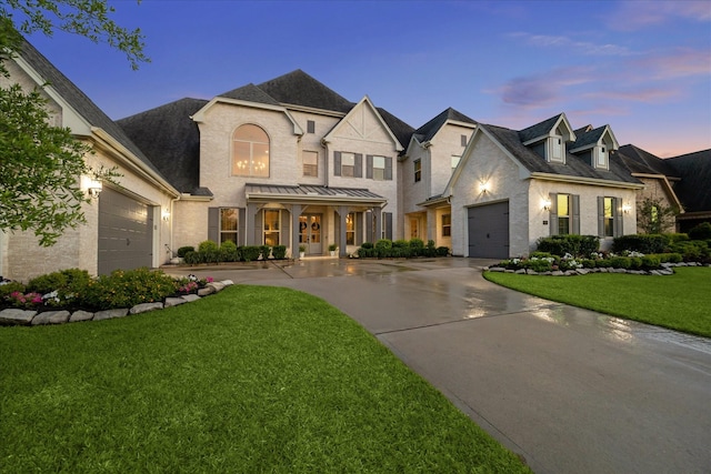 french country inspired facade featuring a porch, a front yard, a garage, concrete driveway, and a shingled roof