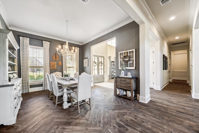 dining space with baseboards, visible vents, ornamental molding, and a notable chandelier
