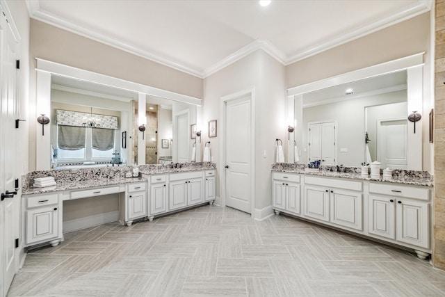 full bathroom featuring two vanities, ornamental molding, and a sink