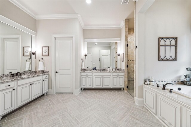 bathroom with ornamental molding, a shower stall, a bath, and two vanities
