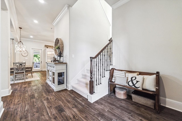 stairway featuring crown molding, baseboards, recessed lighting, and wood finished floors