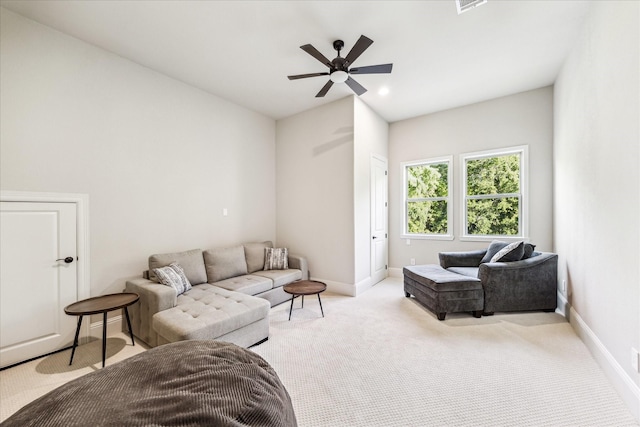 carpeted living room with ceiling fan and baseboards