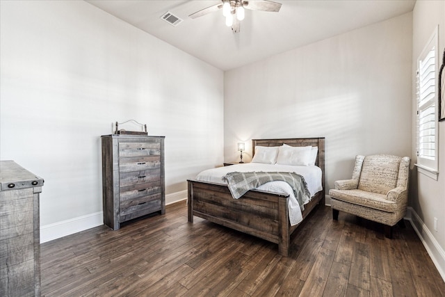 bedroom featuring visible vents, a ceiling fan, baseboards, and dark wood-type flooring