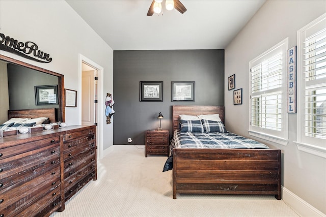 carpeted bedroom featuring baseboards and ceiling fan