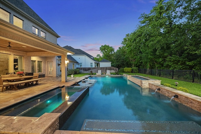 view of pool with a pool with connected hot tub, a ceiling fan, a fenced backyard, and a patio area