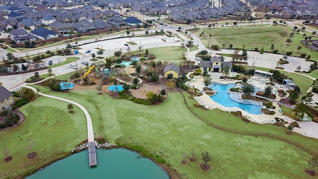drone / aerial view with a residential view and a water view