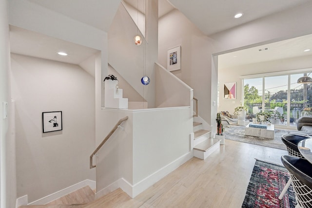 2118 Dennis St, Houston, TX 77004 - staircase featuring baseboards, recessed lighting, and wood finished floors