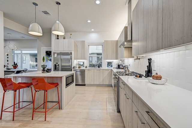 2118 Dennis St, Houston, TX 77004 - kitchen featuring a kitchen island, a kitchen bar, visible vents, appliances with stainless steel finishes, and modern cabinets