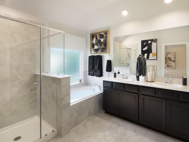 full bathroom featuring a garden tub, a sink, double vanity, and a stall shower