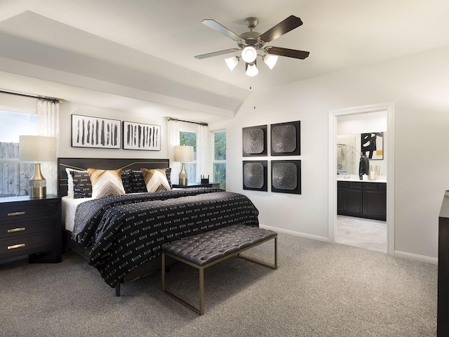 carpeted bedroom featuring ensuite bath, baseboards, vaulted ceiling, and a ceiling fan