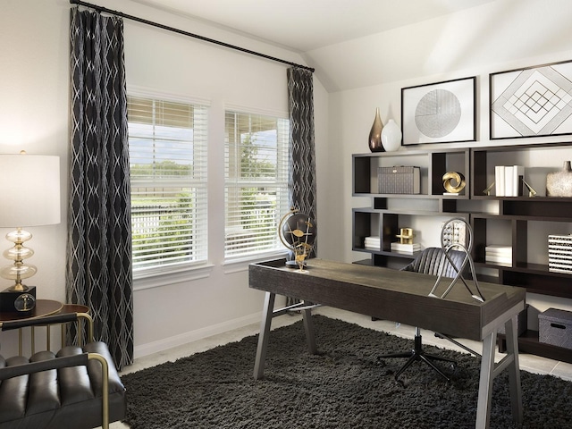 office area with lofted ceiling, carpet flooring, and baseboards