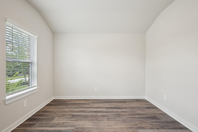 7746 Beaufort Ln, Baytown, TX 77523 - empty room featuring vaulted ceiling, wood finished floors, and baseboards