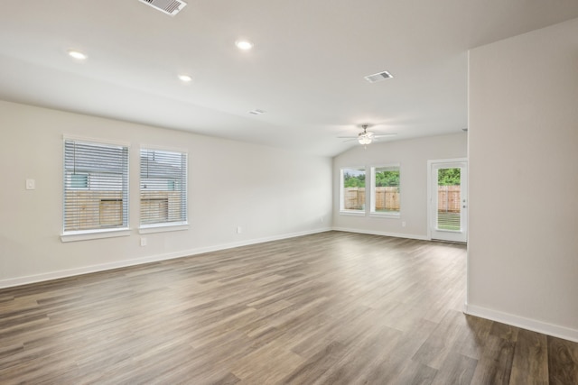 7746 Beaufort Ln, Baytown, TX 77523 - spare room featuring a ceiling fan, baseboards, wood finished floors, recessed lighting, and lofted ceiling