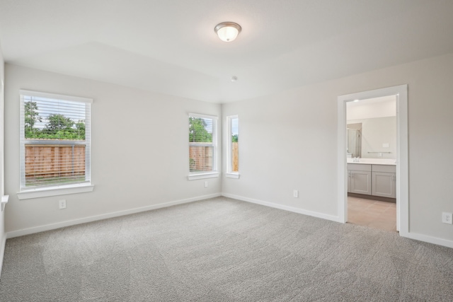 7746 Beaufort Ln, Baytown, TX 77523 - unfurnished bedroom featuring light carpet, baseboards, and ensuite bath