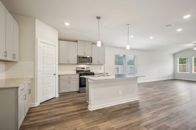 7746 Beaufort Ln, Baytown, TX 77523 - kitchen with appliances with stainless steel finishes, dark wood-style flooring, tasteful backsplash, a ceiling fan, and open floor plan
