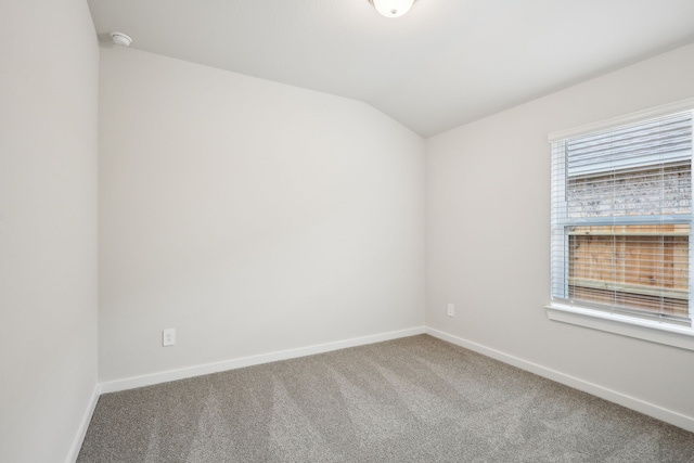 7746 Beaufort Ln, Baytown, TX 77523 - carpeted empty room featuring baseboards, lofted ceiling, and a smoke detector