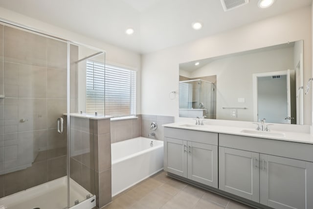 7746 Beaufort Ln, Baytown, TX 77523 - full bathroom featuring a stall shower, double vanity, a bath, recessed lighting, and tile patterned floors