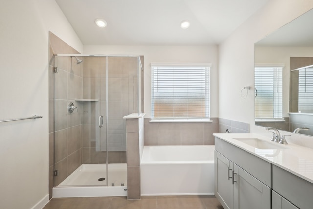 7746 Beaufort Ln, Baytown, TX 77523 - bathroom featuring vanity, healthy amount of natural light, a bath, a shower stall, and recessed lighting