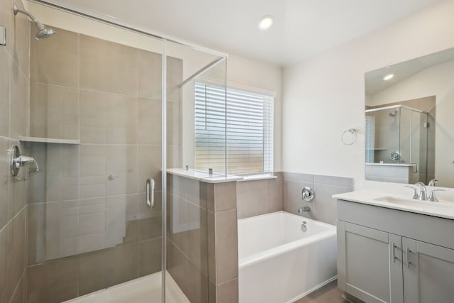 7746 Beaufort Ln, Baytown, TX 77523 - bathroom featuring vanity, a bath, a stall shower, and recessed lighting