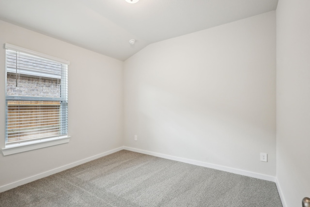 7746 Beaufort Ln, Baytown, TX 77523 - empty room with carpet flooring, baseboards, and vaulted ceiling