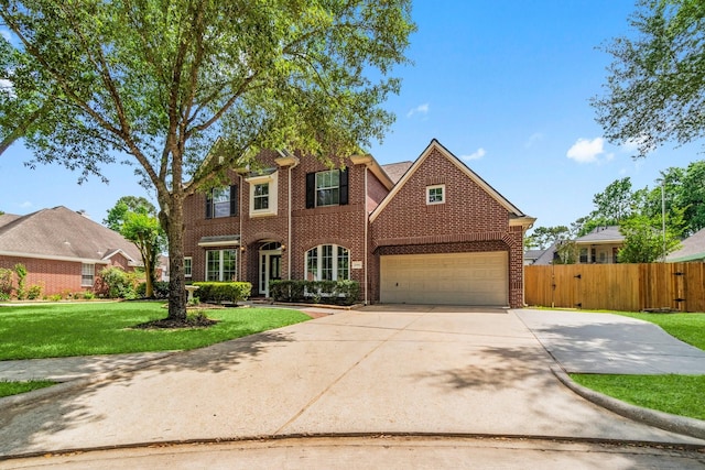20960 Sweetwood Cir, Porter, TX 77365 - traditional-style house featuring a front lawn, driveway, an attached garage, fence, and brick siding