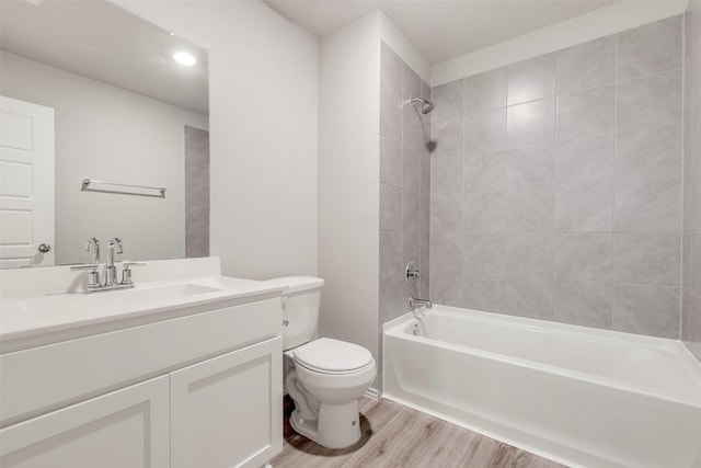 438 Camas Creek Ln, Magnolia, TX 77354 - full bathroom featuring vanity, tub / shower combination, toilet, and wood finished floors