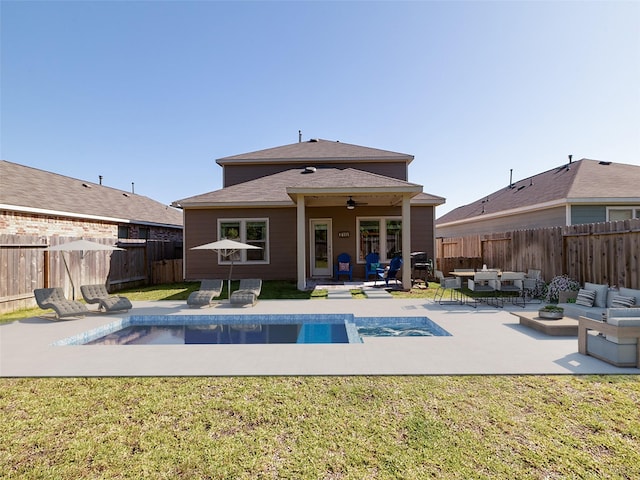 438 Camas Creek Ln, Magnolia, TX 77354 - back of house featuring a yard, a patio area, a fenced backyard, and outdoor lounge area