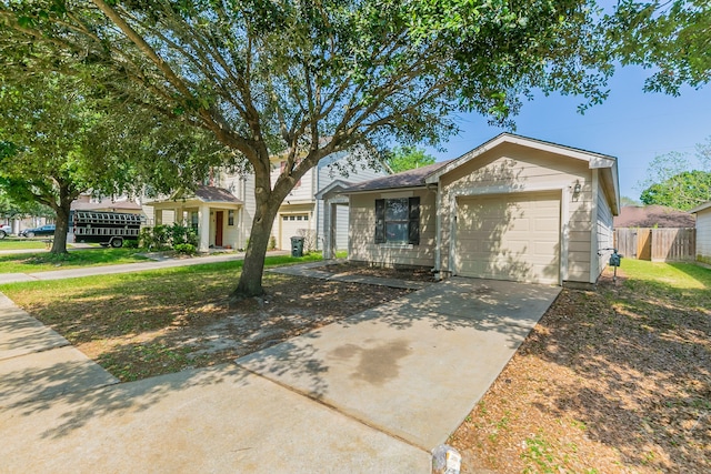 ranch-style house with fence, driveway, and a garage