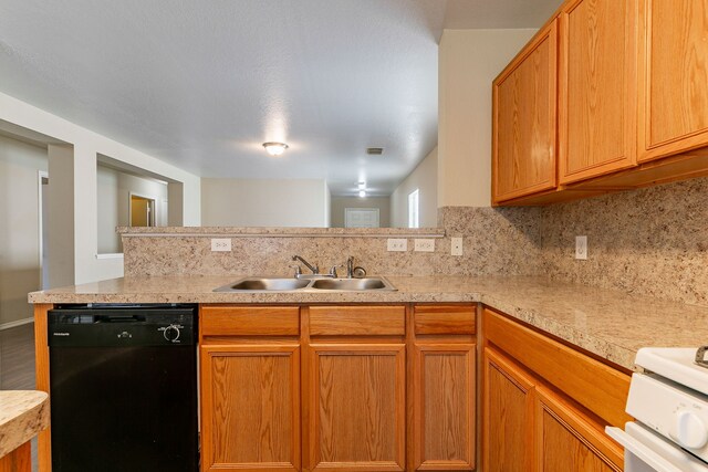 kitchen featuring light countertops, dishwasher, a sink, decorative backsplash, and range