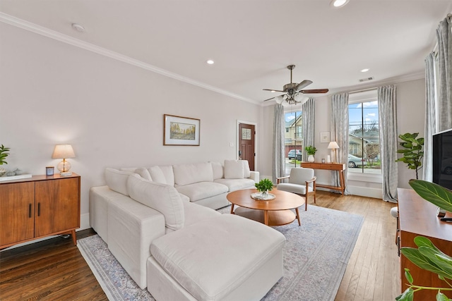 living room with hardwood / wood-style flooring, a ceiling fan, crown molding, and recessed lighting