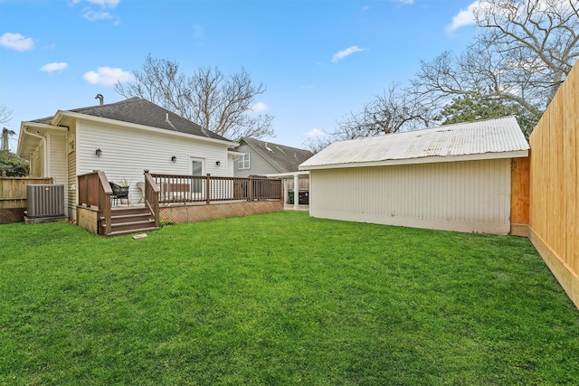 rear view of property with a wooden deck, a fenced backyard, a yard, and central AC