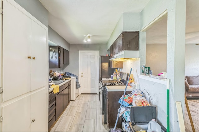 kitchen featuring light countertops, dark brown cabinets, and stainless steel appliances
