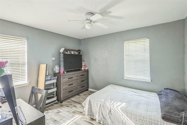 bedroom featuring baseboards and ceiling fan