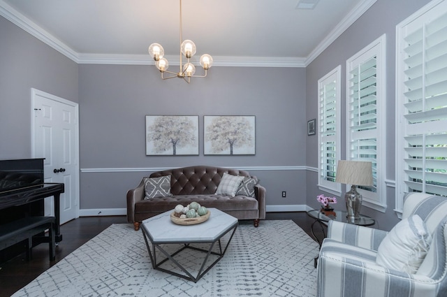 living area featuring crown molding, baseboards, a notable chandelier, and wood finished floors