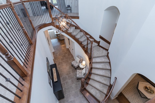 stairs featuring arched walkways and a towering ceiling