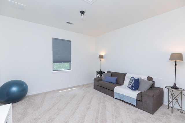 carpeted living area featuring baseboards and visible vents