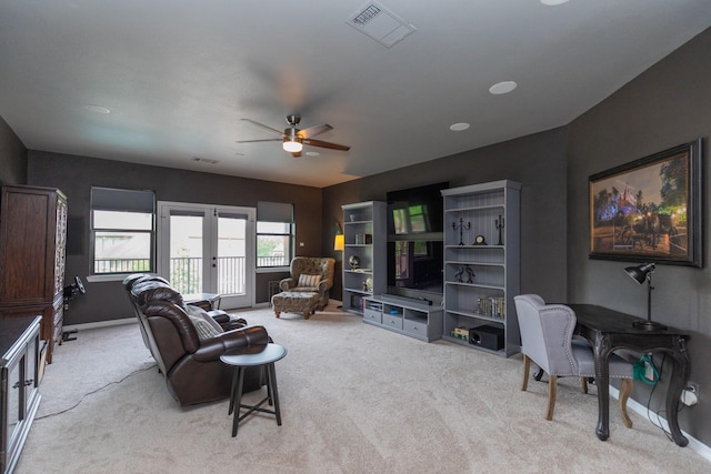 living area featuring ceiling fan, light carpet, french doors, and visible vents