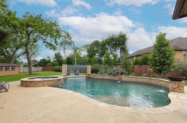 view of swimming pool featuring a pool with connected hot tub, an outbuilding, a fenced backyard, and a patio area