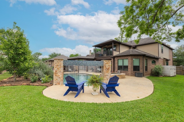 back of property with a balcony, a patio, a fenced backyard, a fenced in pool, and a lawn