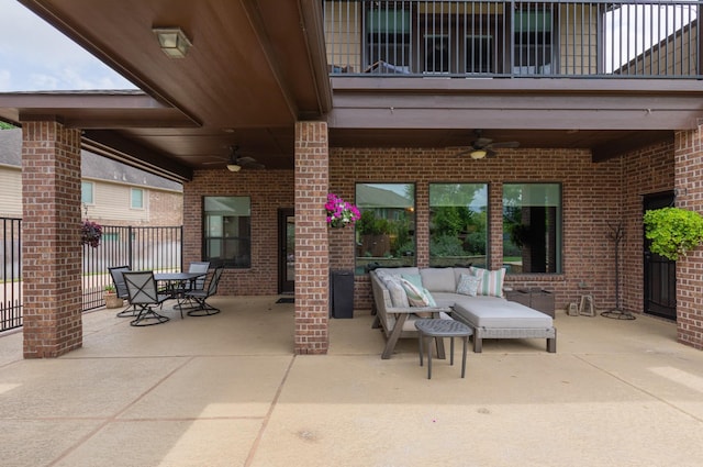 view of patio / terrace featuring ceiling fan, an outdoor living space, outdoor dining area, fence, and a balcony