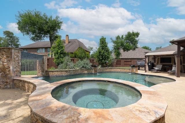 view of pool with an in ground hot tub, a patio area, a gazebo, a fenced in pool, and a fenced backyard