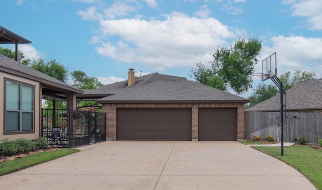 exterior space featuring brick siding, fence, concrete driveway, an attached garage, and a shingled roof