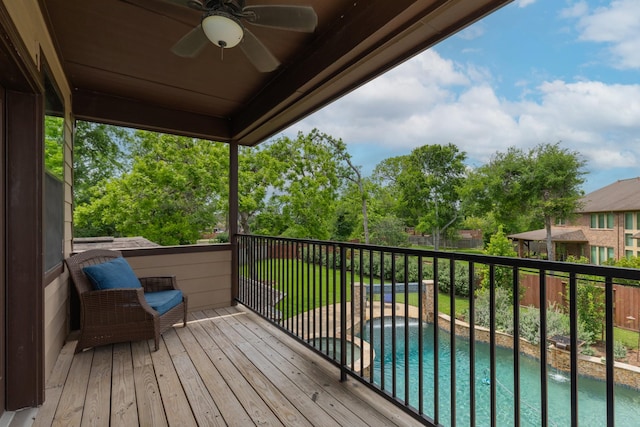 wooden deck with a fenced backyard, a ceiling fan, and an outdoor pool