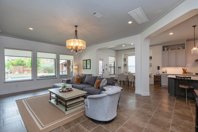 living room with arched walkways, baseboards, visible vents, and recessed lighting