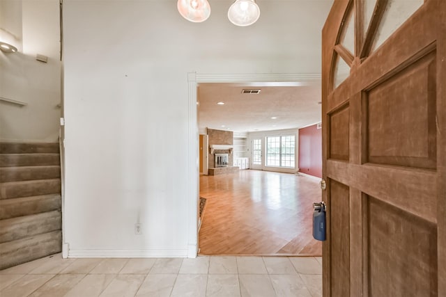 9402 Stockport Dr, Spring, TX 77379 - hall with stairs, light tile patterned floors, baseboards, and recessed lighting