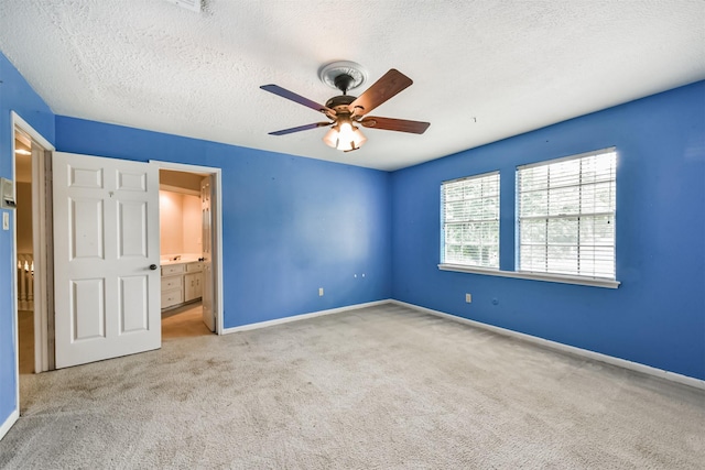 9402 Stockport Dr, Spring, TX 77379 - unfurnished bedroom with carpet floors, a textured ceiling, baseboards, ensuite bath, and a ceiling fan